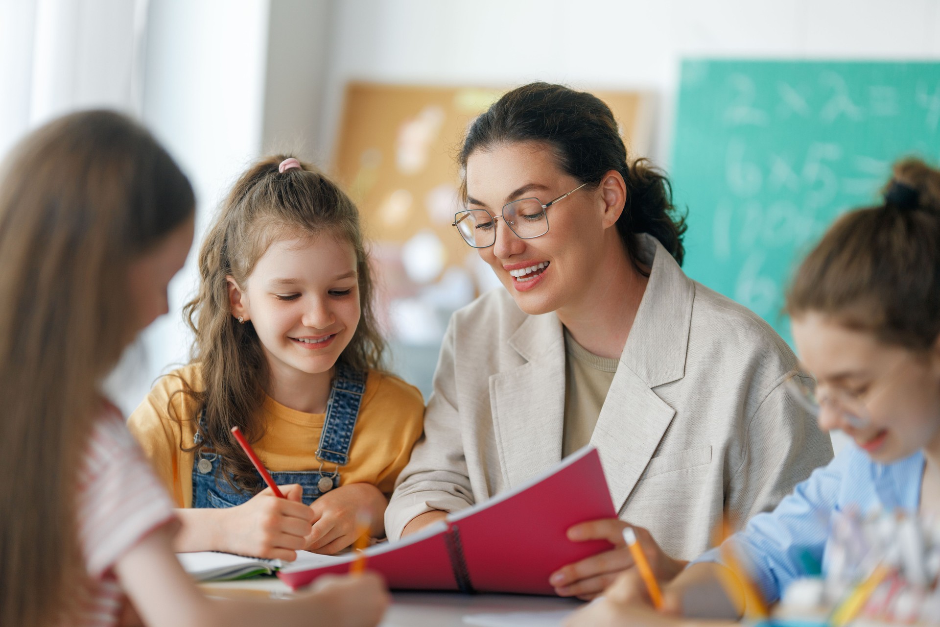 Happy kids and teacher at preschool