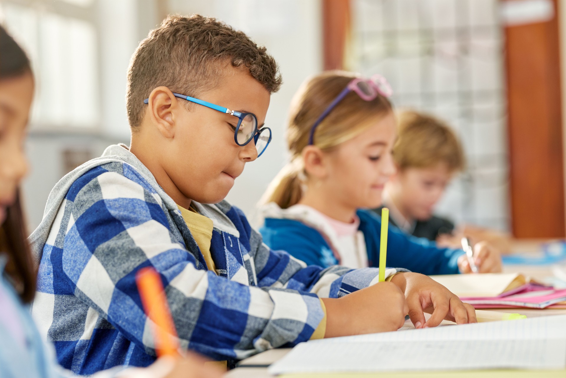 Schoolboy doing homework in classroom